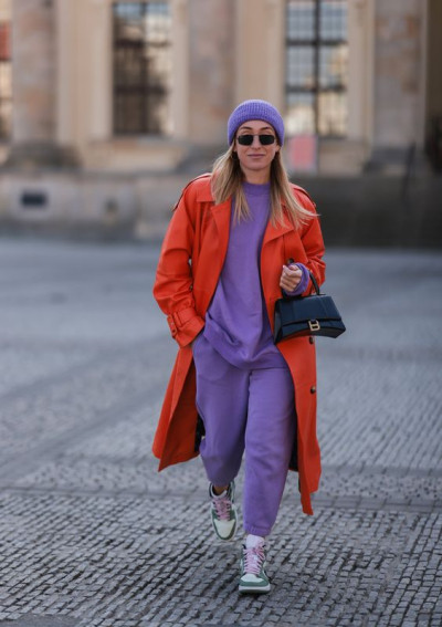 Comfortable wear with t-shirt: orange trench coat,  purple and violet jeans,  grey sneaker,  grey trainer,  orange and purple and violet,  orange trench coat and purple and violet jeans  